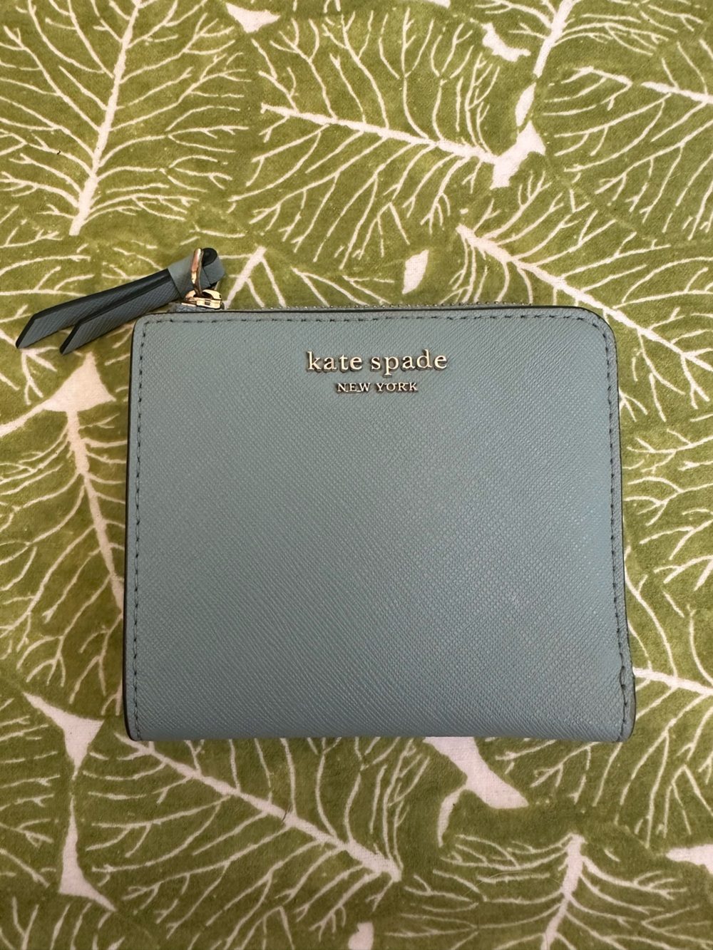 kate spade light blue zip-around compact wallet with gold logo